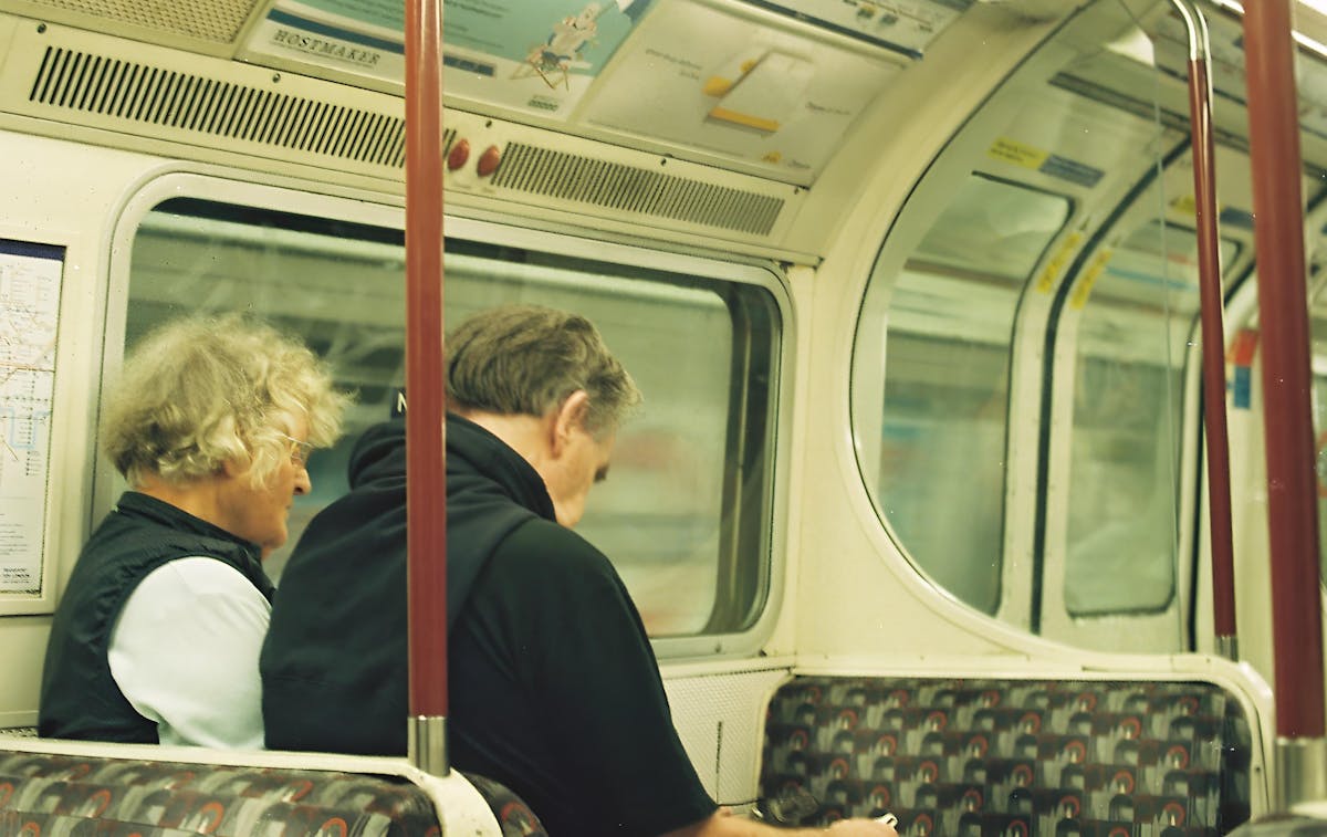 Passengers sitting inside a subway carriage during a late-night journey