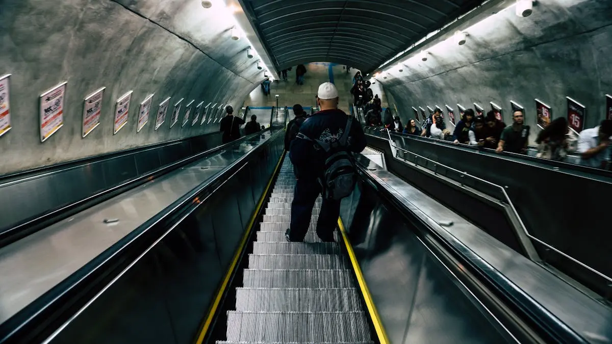 Passenger on an Underground station escalator in London